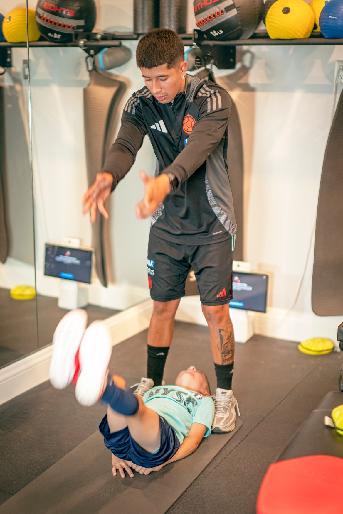Coach providing instruction during a youth soccer drill